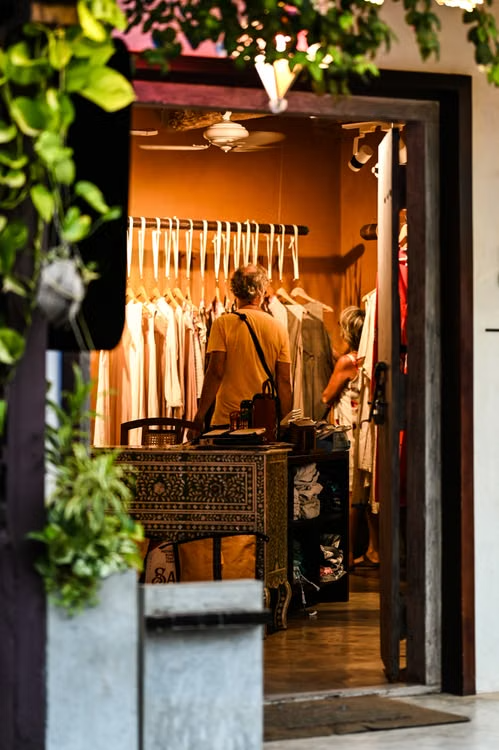 Warmly lit Indian boutique doorway with garments on display